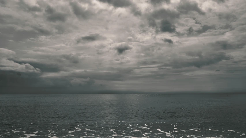 a large body of water under a cloudy sky, a black and white photo, inspired by Elsa Bleda, unsplash, ignant, the sea of sadness, seaview, album