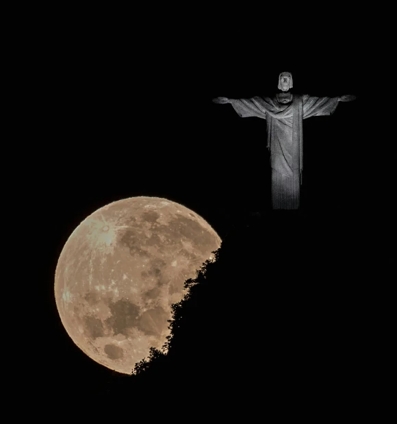 a full moon with a statue in the background, an album cover, by Giorgio Cavallon, pexels contest winner, christ the redeemer, white moon and black background, cross, leaked from nasa