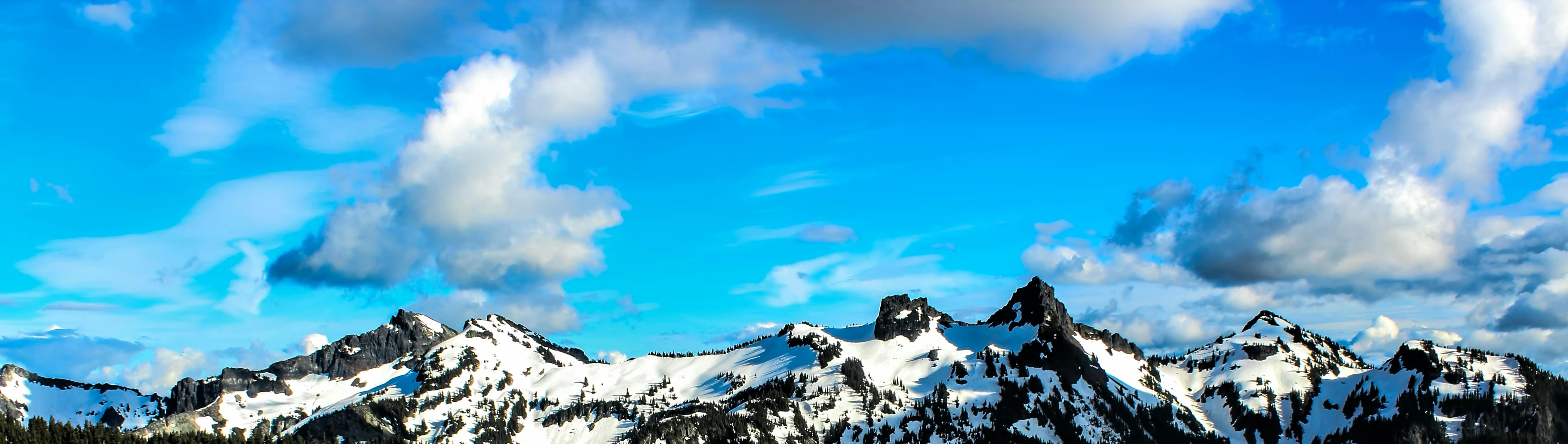 a group of people riding skis down a snow covered slope, a tilt shift photo, by Meredith Dillman, pexels contest winner, blue sky with a few clouds, floating island in the sky, thumbnail, pacific northwest