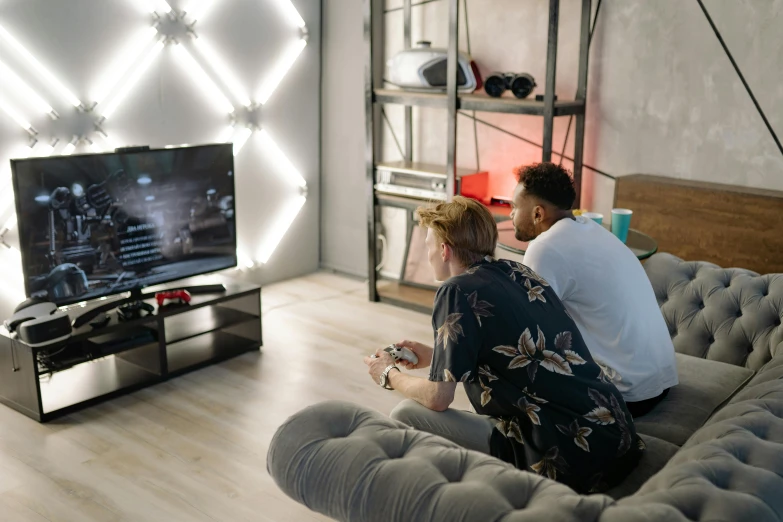 a man and a woman sitting on a couch playing a video game, pexels contest winner, gamer screen on metallic desk, fancy apartment, vga, sport game