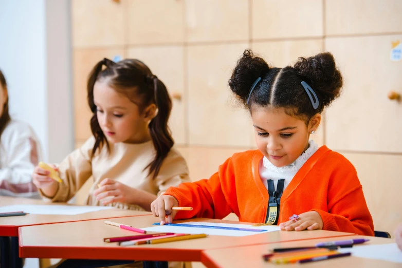 two young girls sitting at a table with colored pencils, trending on pexels, ashcan school, girl wearing uniform, riyahd cassiem, on a canva, profile image