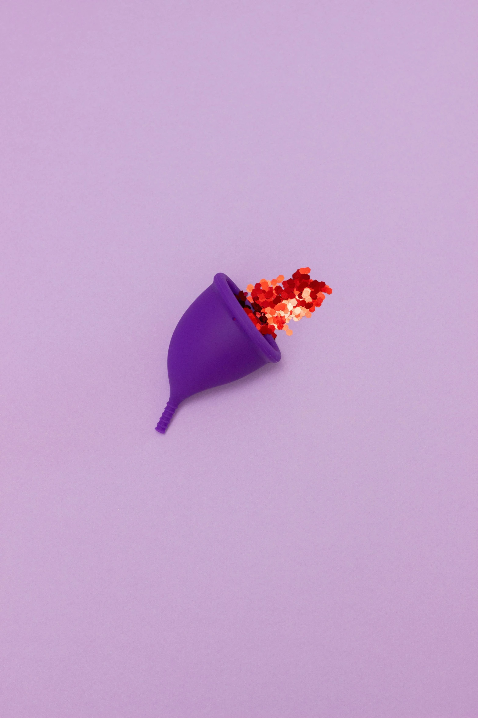 a purple cone sitting on top of a purple surface, by Elsa Bleda, conceptual art, tiny crimson petals falling, contracept, lgbtq, paprika