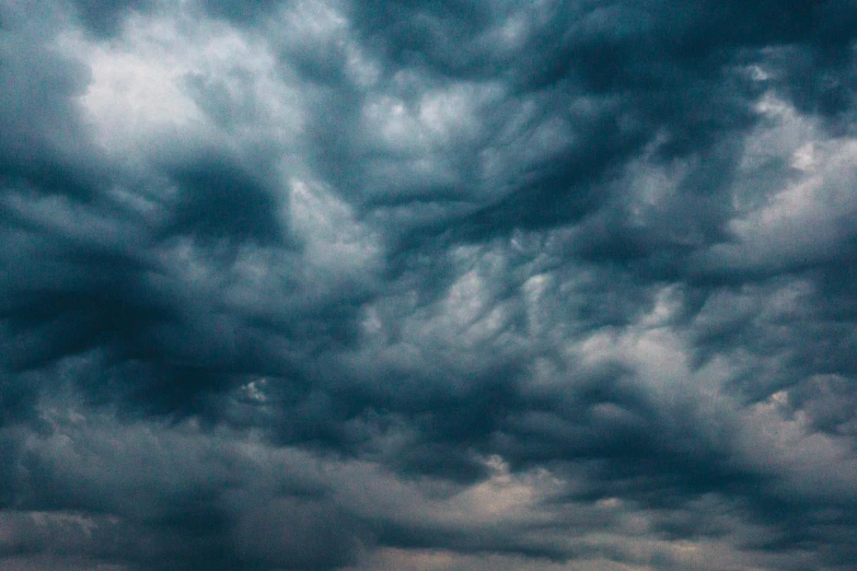 a large body of water under a cloudy sky, dark mammatus cloud, instagram post, turbulence, low angle facing sky