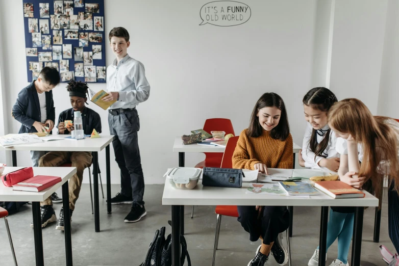 a group of people sitting at desks in a classroom, trending on pexels, danube school, standing upright, promotional image, eva elfie, teenager hangout spot