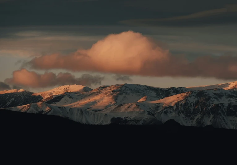 a mountain covered in snow under a cloudy sky, pexels contest winner, aestheticism, dramatic reddish light, late afternoon lighting, grey, cinematic render