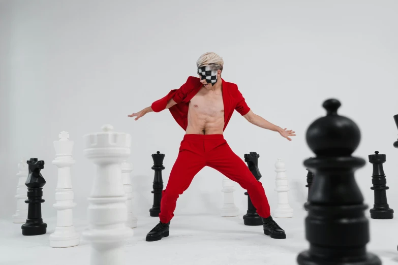 a man in a red suit is surrounded by chess pieces, an album cover, inspired by Horace Vernet, trending on pexels, antipodeans, playful pose of a dancer, xqc, lycra costume, youtube thumbnail