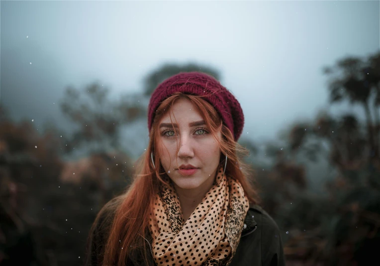 a woman with red hair wearing a scarf and a hat, inspired by Elsa Bleda, trending on pexels, overcast mood, teenage girl, freckled, a mountain look like a women