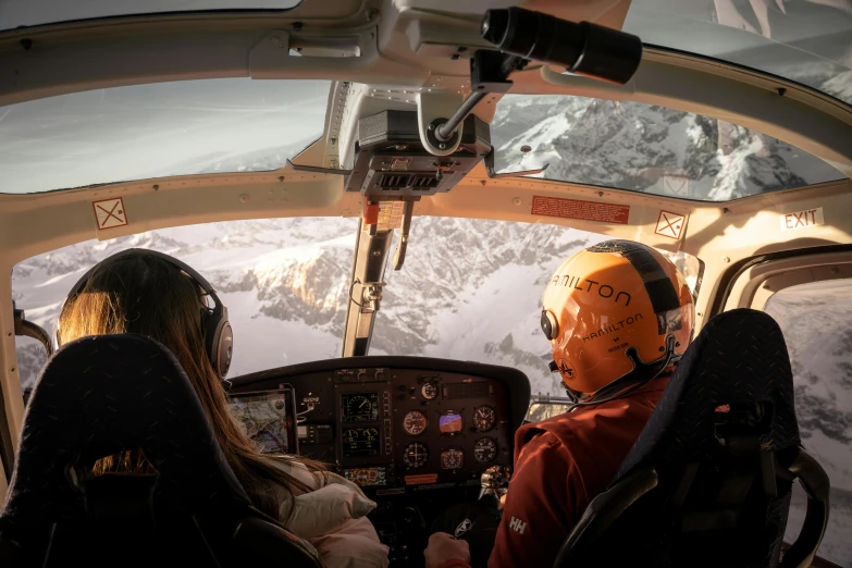 a couple of people that are sitting in a plane, helmet view, glacier, with people inside piloting it, brown