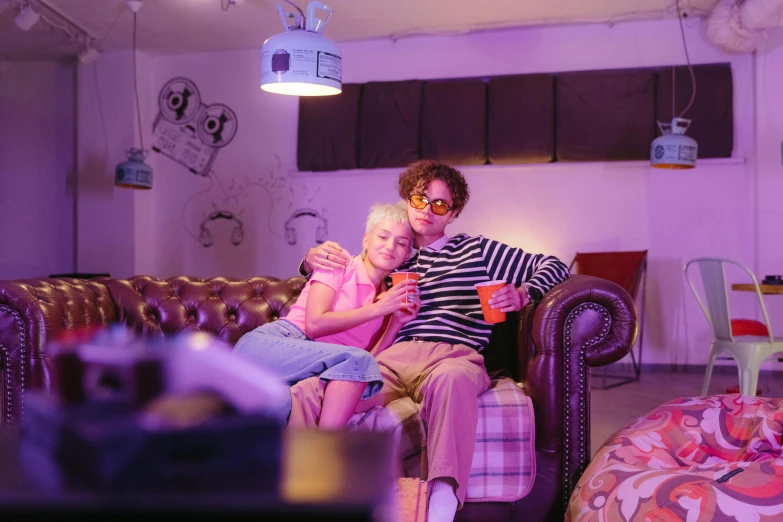 a man and a woman sitting on a couch, by Nick Fudge, interactive art, colourful lighting, ' ramona flowers ', family friendly, lesbians