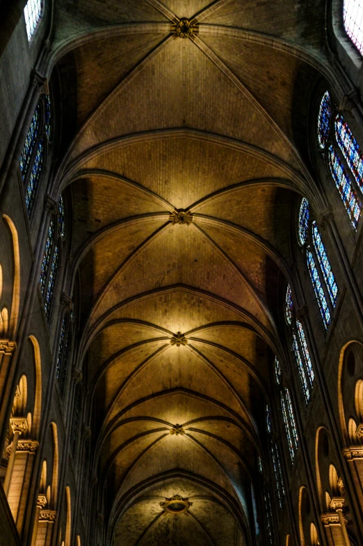 the inside of a cathedral with stained glass windows, inspired by Barthélemy d'Eyck, romanesque, flying buttresses, wide overhead shot, dark gothic cathedral, symmetrical detail