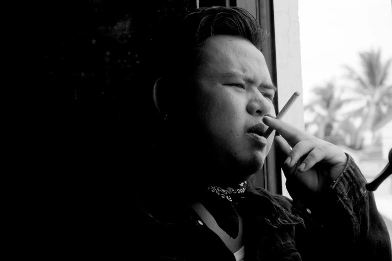a black and white photo of a man smoking a cigarette, a black and white photo, inspired by Gang Hui-an, unsplash, sumatraism, overweight!! teenage boy, yanjun chengt, people with mohawks, looking outside