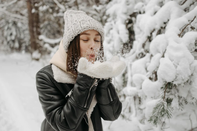 a woman blowing snow in a snowy forest, pexels contest winner, leather clothes, profile image, thumbnail, bubbly