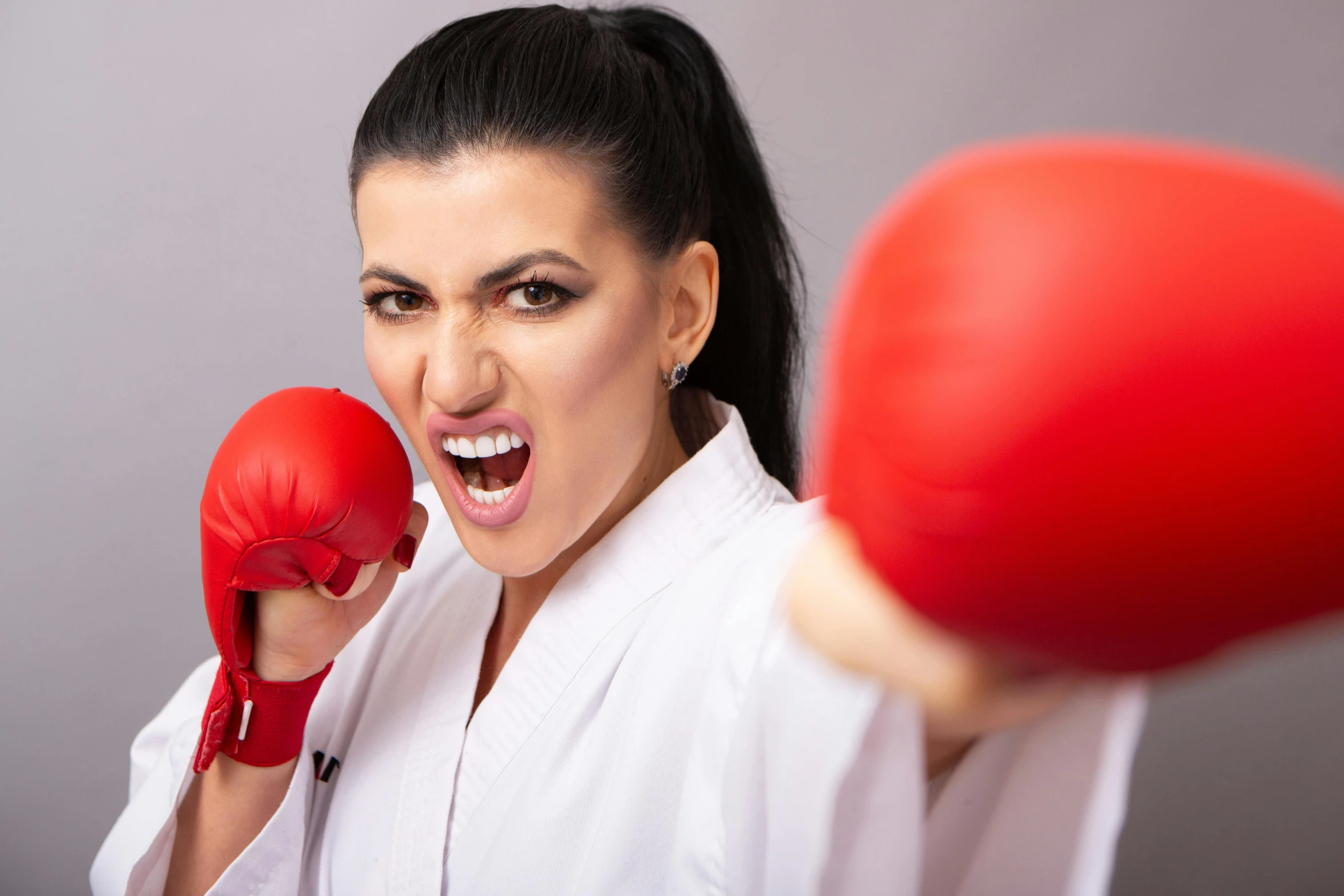 a woman in white shirt and red boxing gloves, inspired by Daryush Shokof, shutterstock contest winner, arabesque, angry and pointing, youtube thumbnail, healthcare, portrait of tifa lockhart