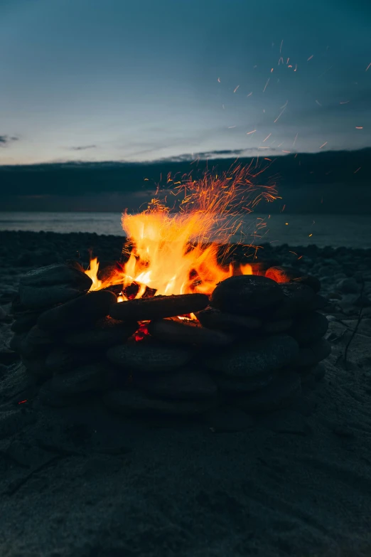 a bonfire sitting on top of a sandy beach, whirling gasses, fire and brimstone, profile image, multiple stories