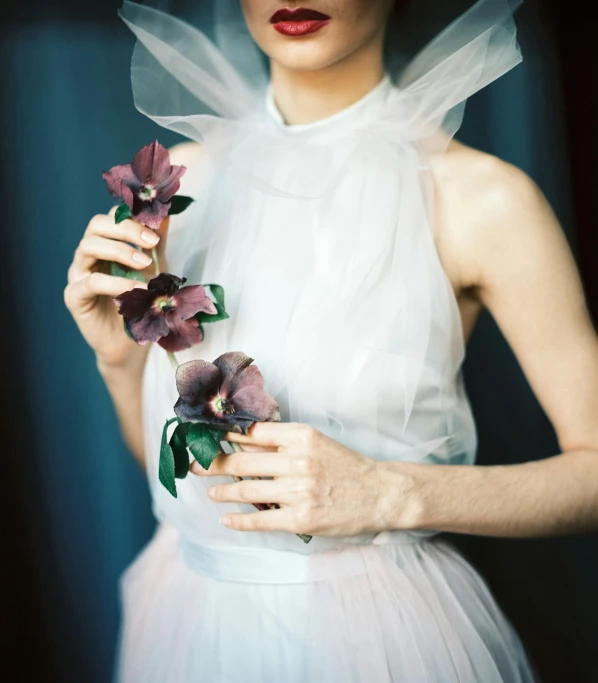a woman in a white dress holding a flower, an album cover, by Sara Saftleven, unsplash, romanticism, vera wang couture, her face is a mauve flower, portra 160, wedding