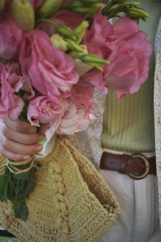 a woman holding a bouquet of pink flowers, inspired by Annabel Kidston, crochet, environmental shot, linen, morning detail