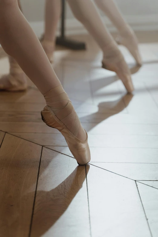 a group of people standing on top of a hard wood floor, by Elizabeth Polunin, pexels contest winner, arabesque, close-up on legs, dynamic reflections, panels, 15081959 21121991 01012000 4k