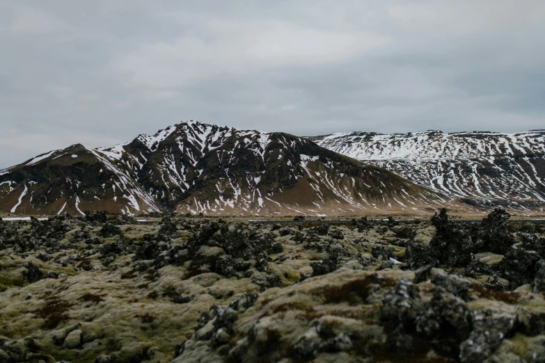 a mountain range with snow covered mountains in the background, by Hallsteinn Sigurðsson, unsplash contest winner, hurufiyya, rocky roads, meat and lichens, background image