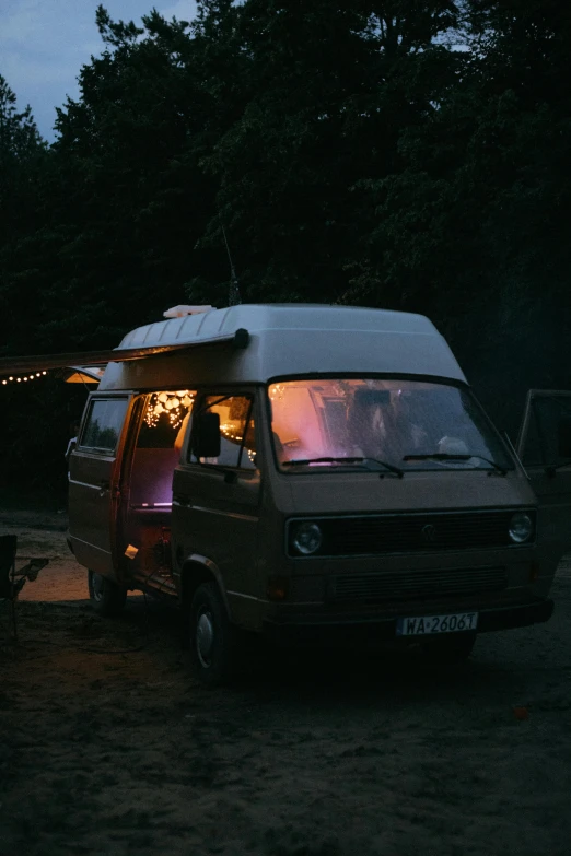 a camper van is parked on the side of the road, by Attila Meszlenyi, ambient lighting, cottagecore hippie, 1990, low iso