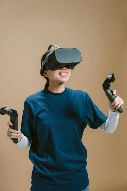 a woman in a blue shirt holding two video game controllers, a digital rendering, hypermodernism, oculus quest 2, motion capture system, joy ang, navy