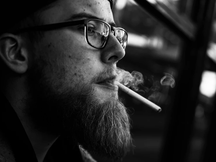 a man with a beard and glasses smoking a cigarette, a black and white photo, by Karl Buesgen, high quality upload, samdoesarts, portrait image