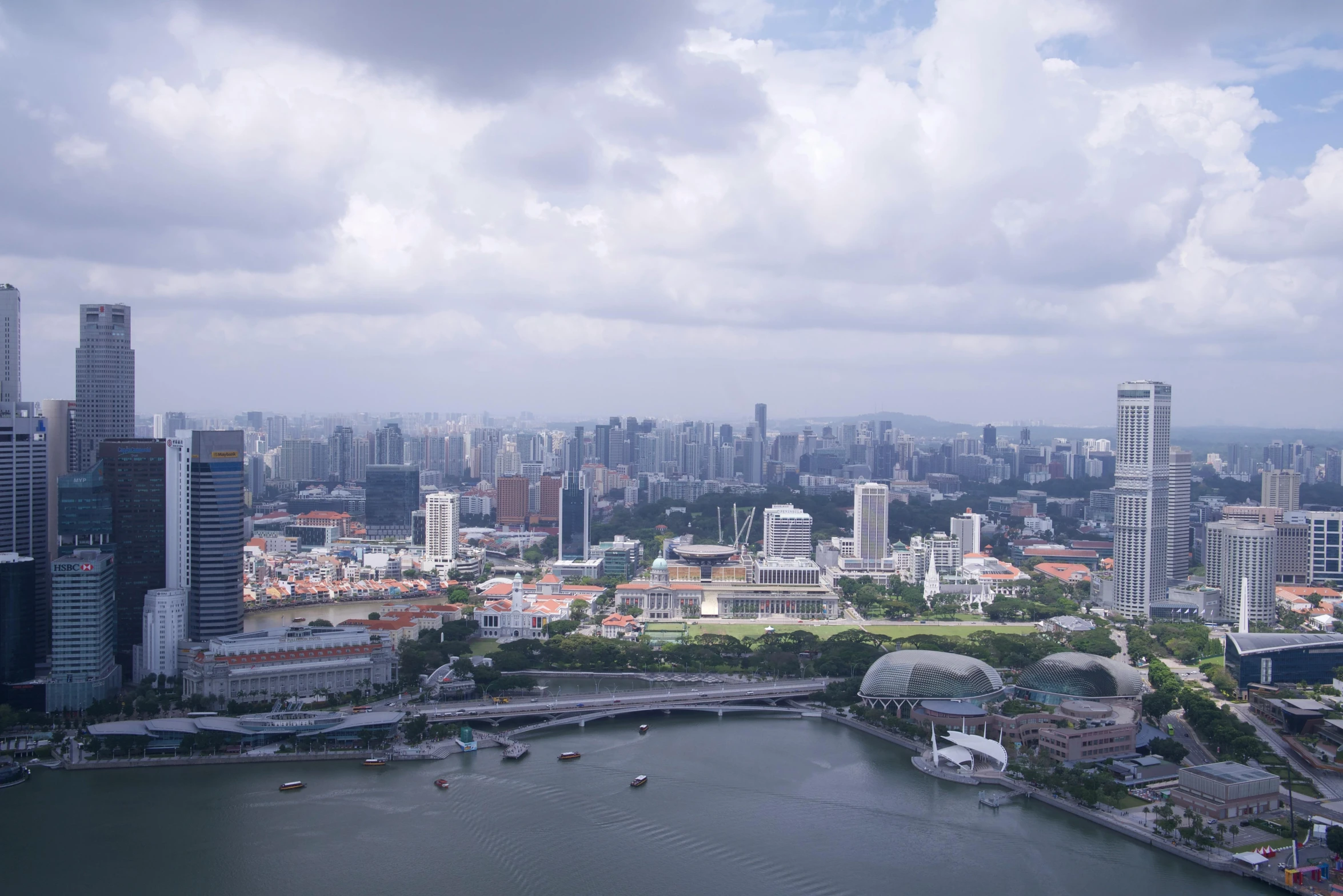 a large body of water surrounded by tall buildings, pexels contest winner, hyperrealism, the singapore skyline, high view, subtitles, multiple stories