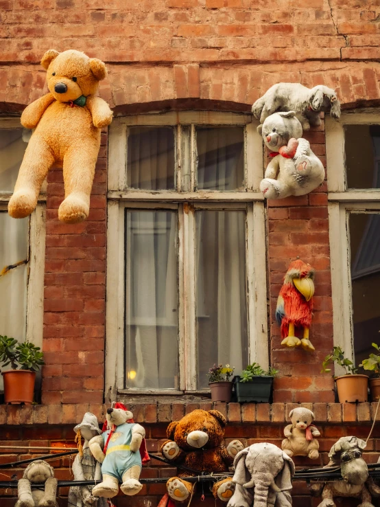 a bunch of stuffed animals hanging from the side of a building, by Jan Tengnagel, pexels contest winner, renaissance, neighborhood outside window, today\'s featured photograph 4k, decorations, high detailed photo