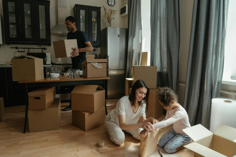 a couple of people that are sitting on the floor, packaging, leaving a room, in australia, profile image