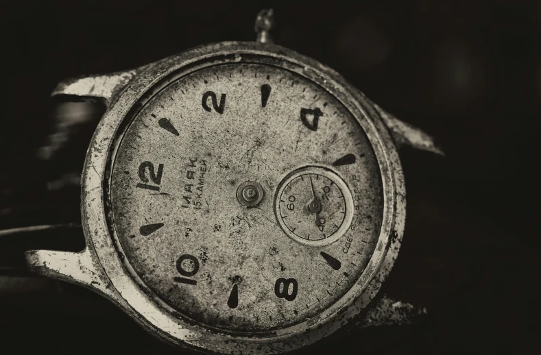 a black and white photo of an old watch, by Adam Marczyński, medium format. soft light, tarnished and rusted metal, thumbnail