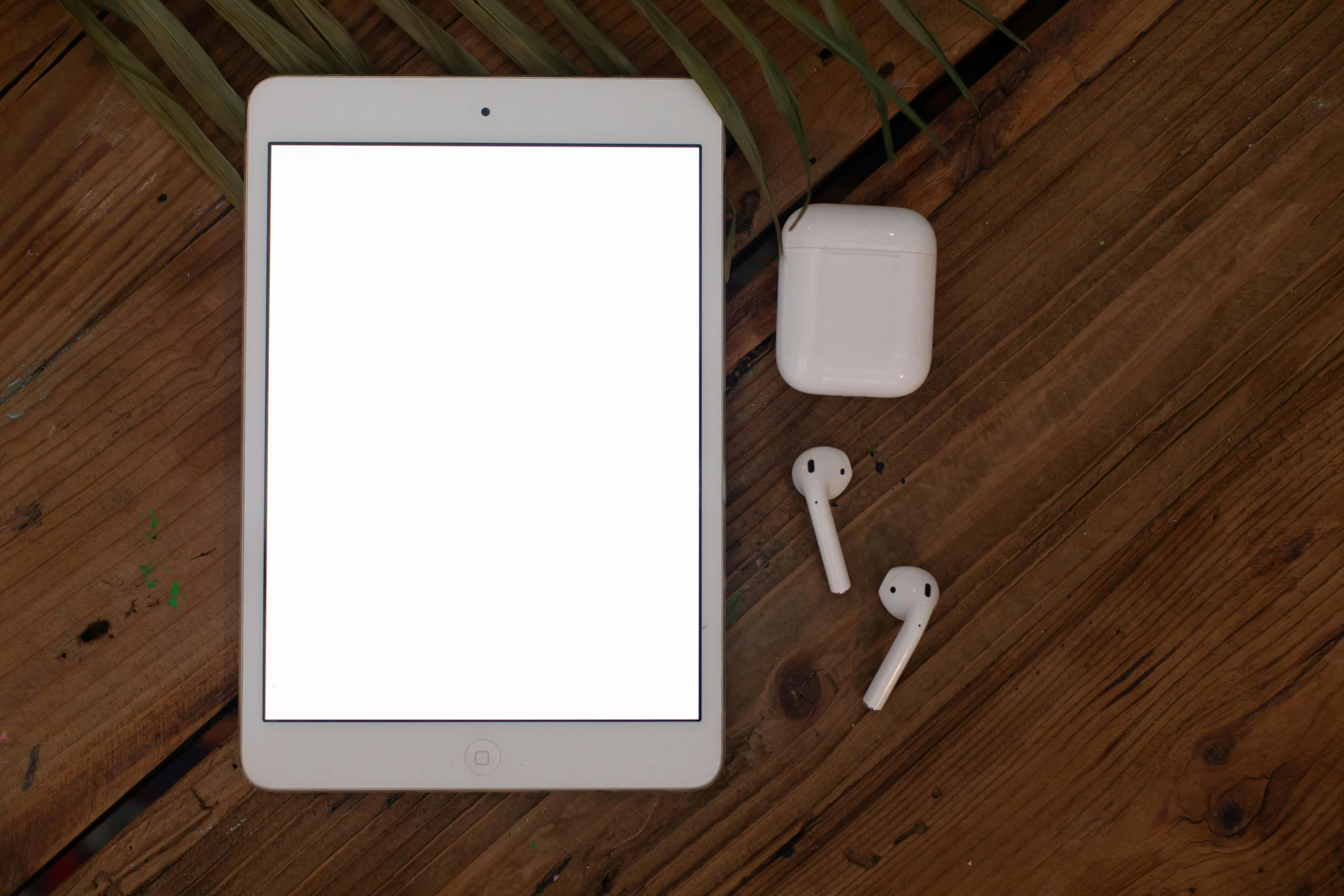 a tablet computer sitting on top of a wooden table, by Carey Morris, pexels, airpods, square, white, blank