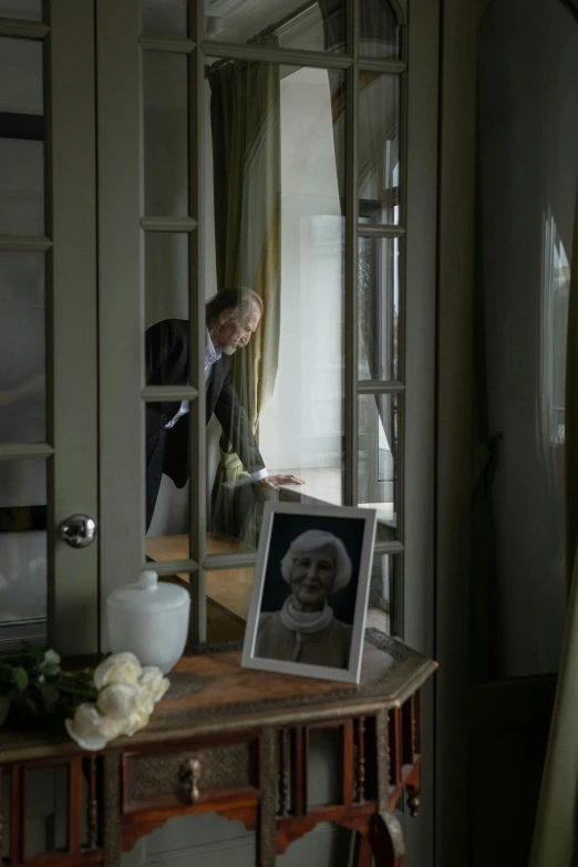 a man that is standing in front of a mirror, a picture, inspired by Willem de Poorter, looking through a window frame, johan liebert, live-action archival footage, delightful surroundings