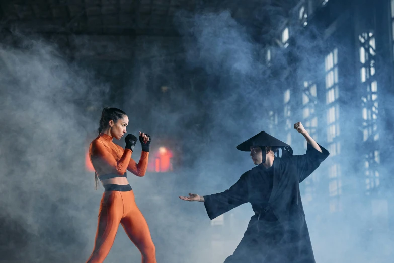 a couple of people standing on top of a stage, inspired by Ma Quan, pexels contest winner, gutai group, ninja outfit, women fighting men, bella poarch, in orange clothes) fight