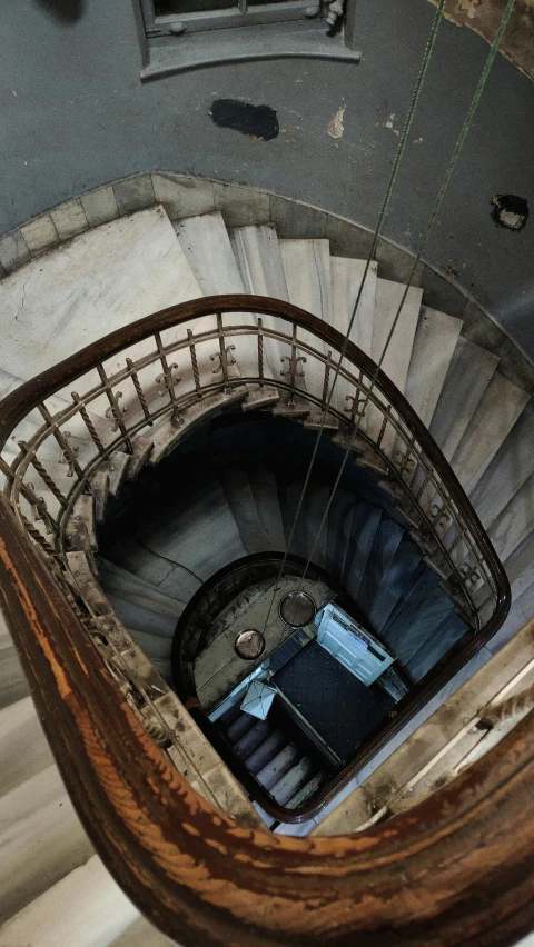 a spiral staircase going up to the top of a building, arte povera, photographed for reuters, inside the sepulchre, high angle, promo image