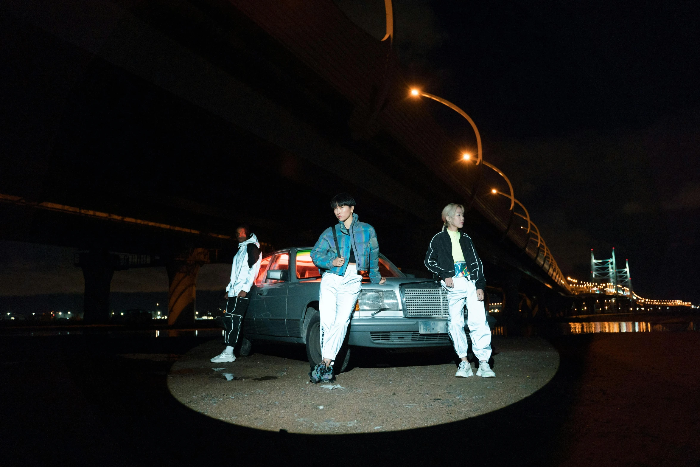 a couple of men standing next to a car, an album cover, inspired by Gang Hui-an, unsplash, hero pose colorful city lighting, generic kpop boy band, 3 - piece, fujicolor photo