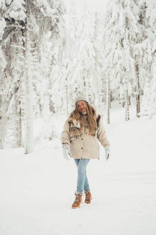 a woman walking through a snow covered forest, by Anna Haifisch, pexels contest winner, wearing off - white style, in mountains, 🎀 🧟 🍓 🧚, happy girl