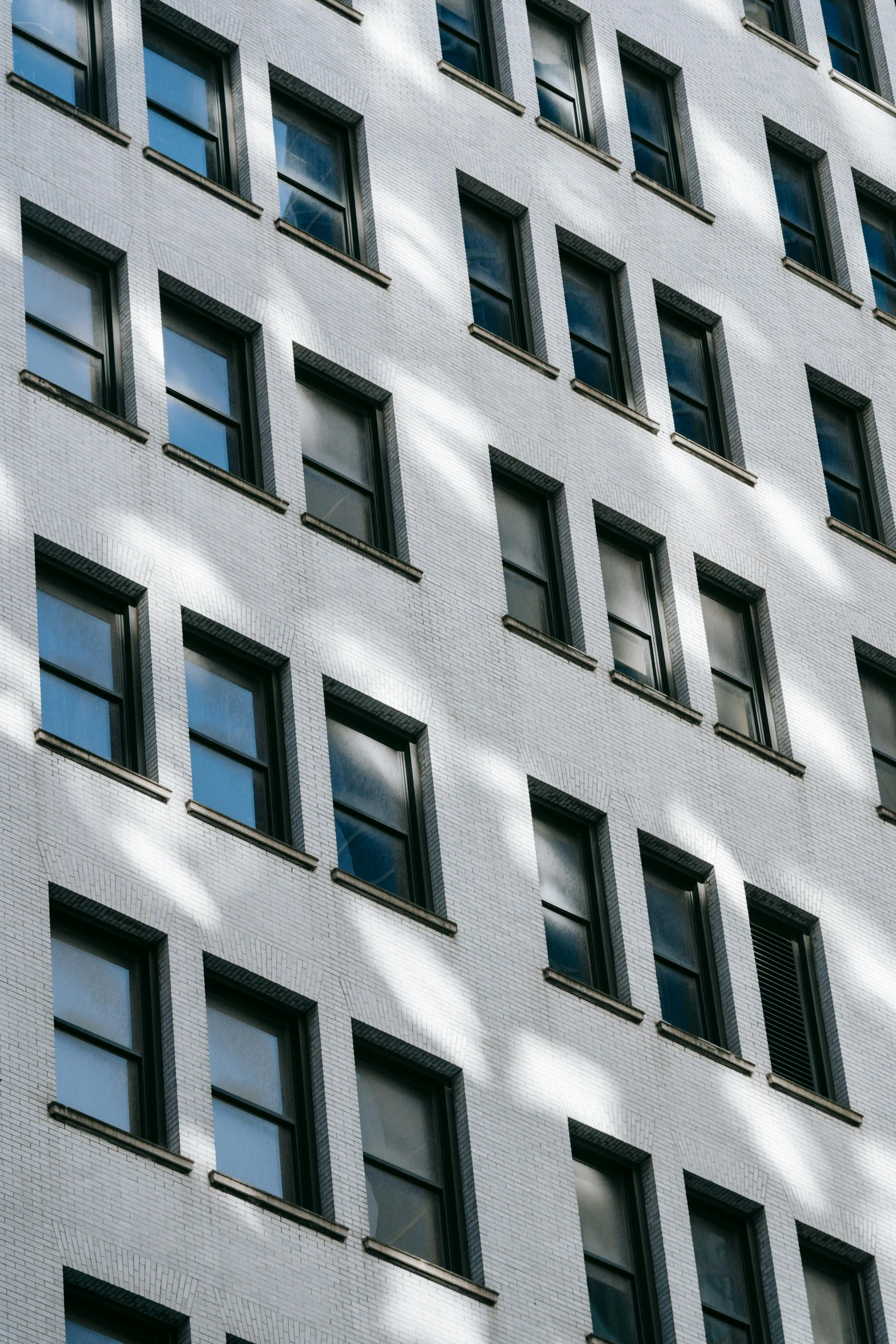a tall white building with lots of windows, inspired by Vivian Maier, unsplash contest winner, dappled sunlight, ignant, square lines, zoomed in shots