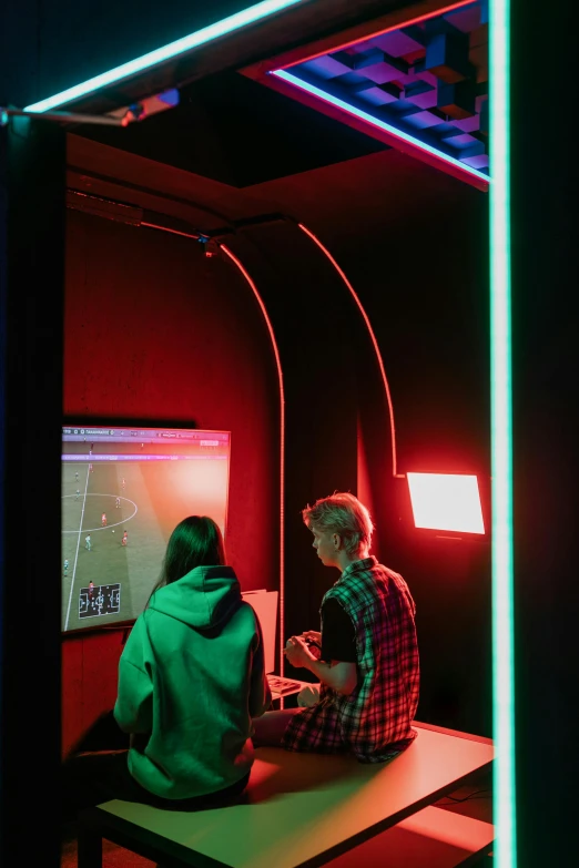 two people sitting at a table playing a video game, by Jacob Toorenvliet, pexels, interactive art, red and green lighting, closed limbo room, 2 5 6 x 2 5 6 pixels, college