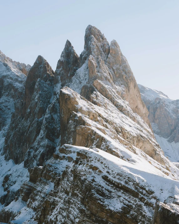 a man riding skis down a snow covered slope, a detailed matte painting, pexels contest winner, tall stone spires, in the dolomites, grain”, “ aerial view of a mountain