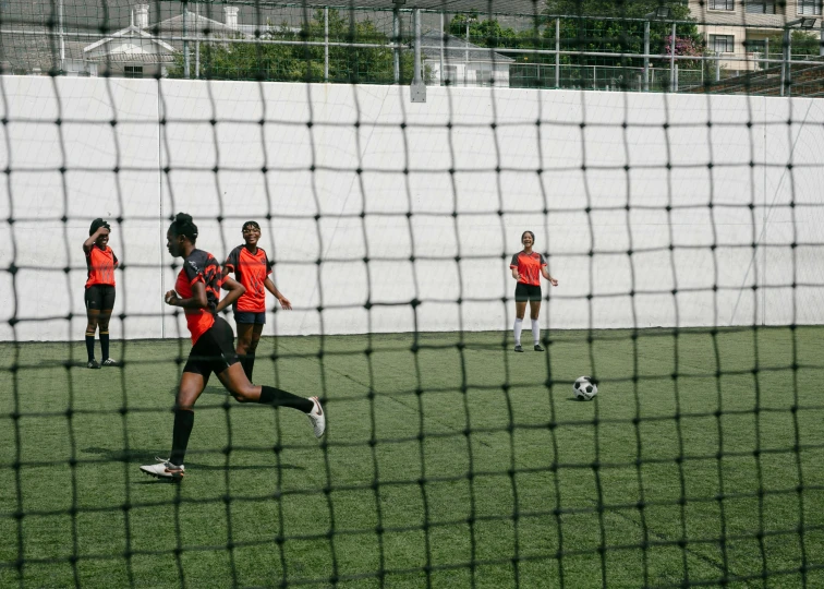 a group of people playing soccer on the field