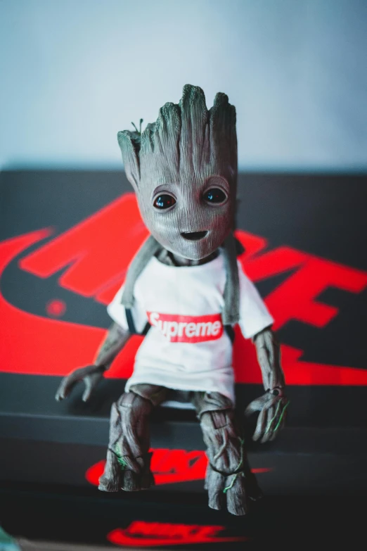 a close up of a figurine of a baby grooter, by Sebastian Spreng, pexels contest winner, groot costume, supreme, trending on r/streetwear, sitting on a table