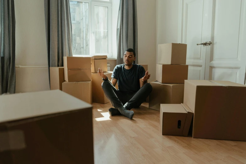 a man sitting on the floor surrounded by boxes, avatar image, ignant, listing image, melbourne