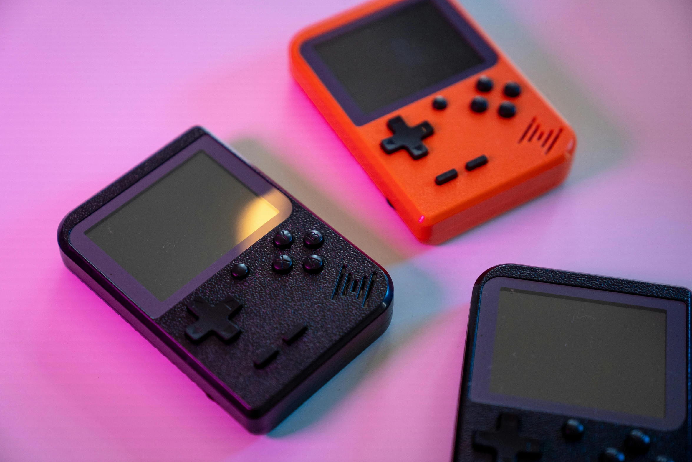a couple of small game consoles sitting on top of a table, 3 d print, superpop ultrabright, 33mm photo, handheld