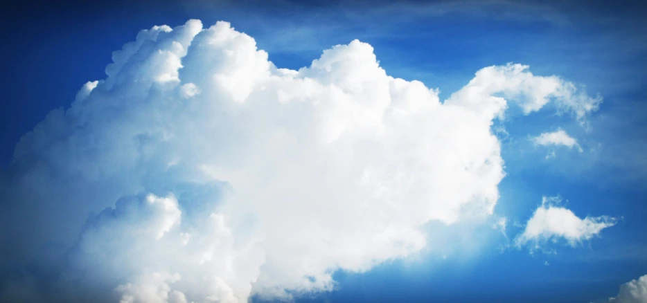 a large cloud in the middle of a blue sky, an album cover, istockphoto, fluffy white clouds, featured art, high quality screenshot