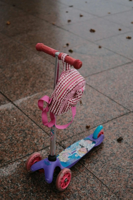 a pink scooter sitting on top of a tiled floor, a picture, rain is falling, striped, broken toys, non-binary