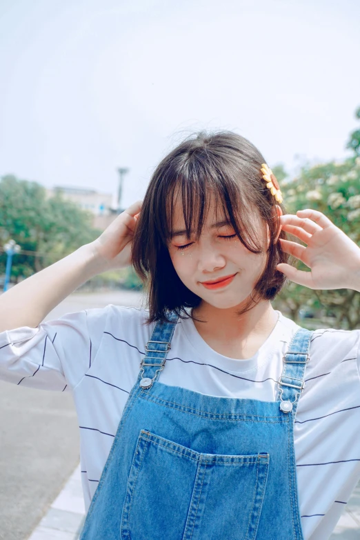 a woman standing on the side of a road with her hands on her head, by Tan Ting-pho, pexels contest winner, realism, cute kawaii girl, wearing overalls, wearing stripe shirt, 2263539546]