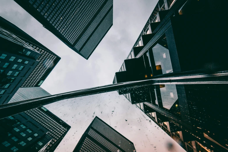 a group of tall buildings in a city, a picture, pexels contest winner, hypermodernism, wet reflections in square eyes, low angle fisheye view, thumbnail, 1 2 9 7