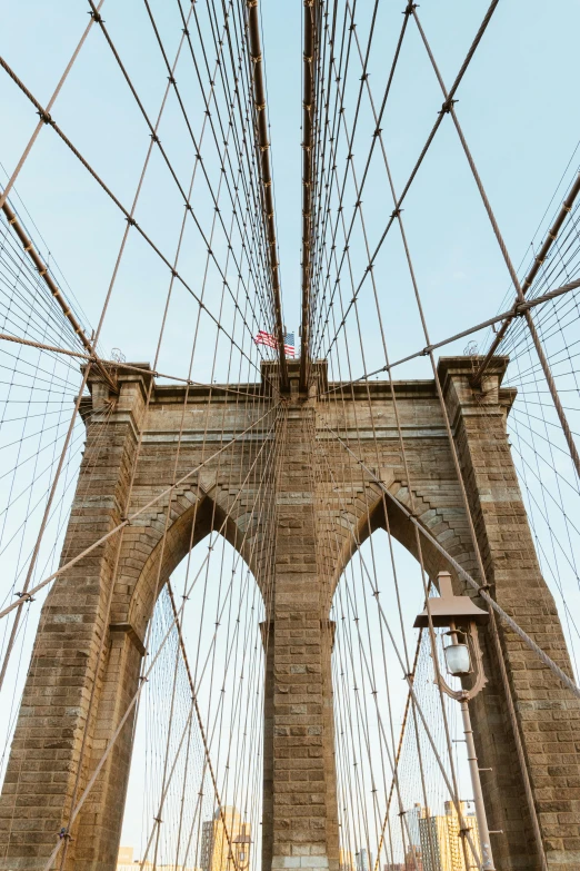 a group of people walking across a bridge, inspired by Christo, trending on unsplash, hudson river school, flying buttresses, close up front view, brooklyn, a middle-shot from front