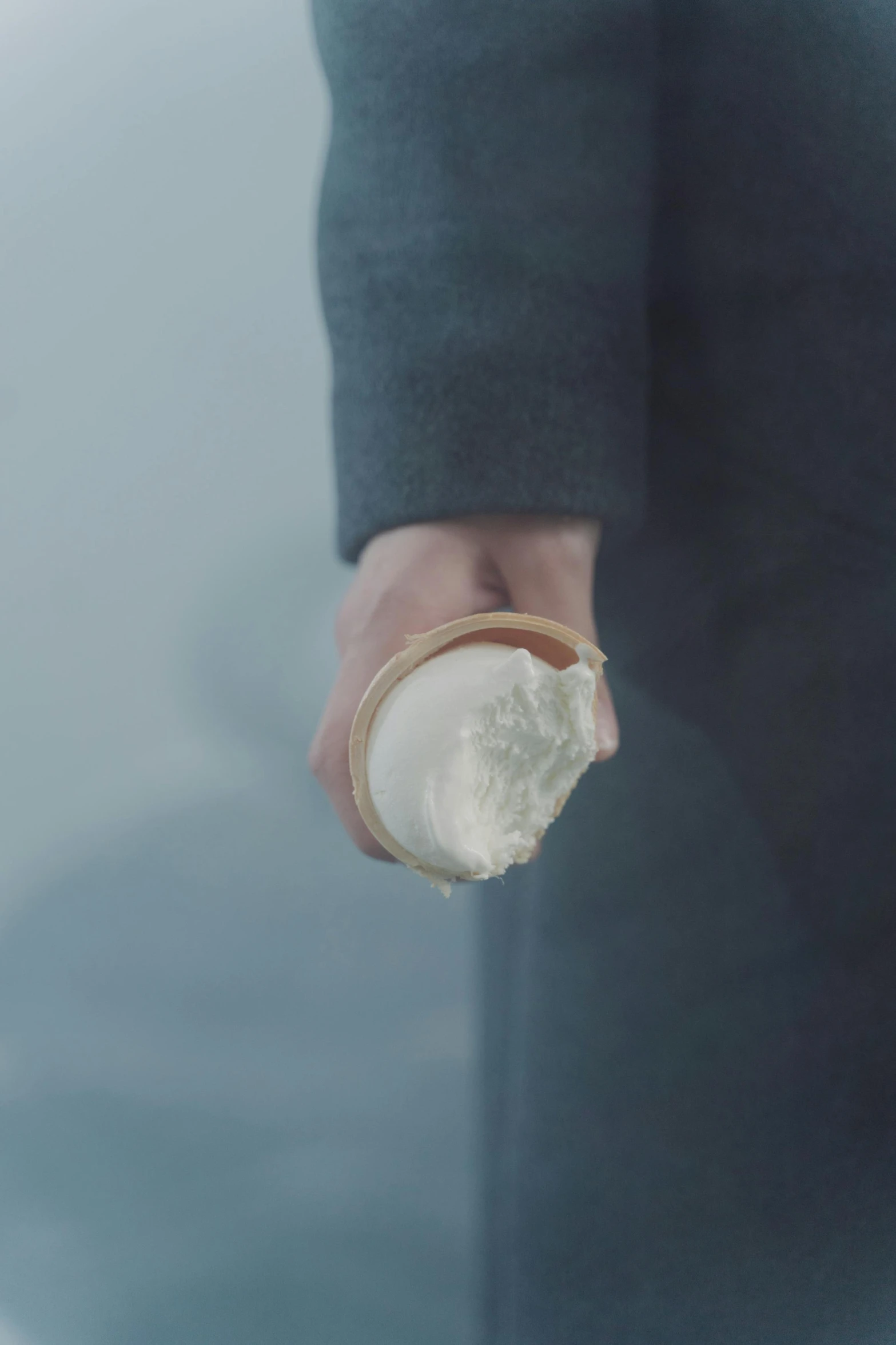 a close up of a person holding something in their hand, inspired by Zhang Kechun, unsplash, conceptual art, whipped cream, ignant, movie still 8 k, cold weather