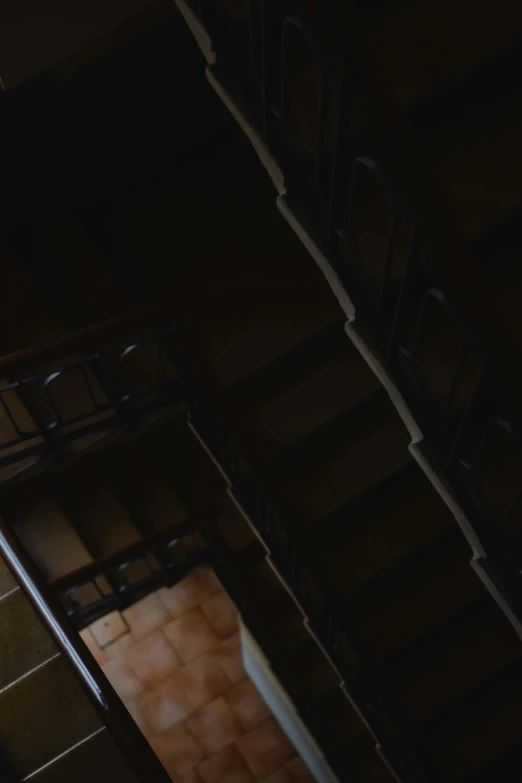 a couple of stairs that are next to each other, an album cover, unsplash, renaissance, cinematic footage, brown, dark, ignant