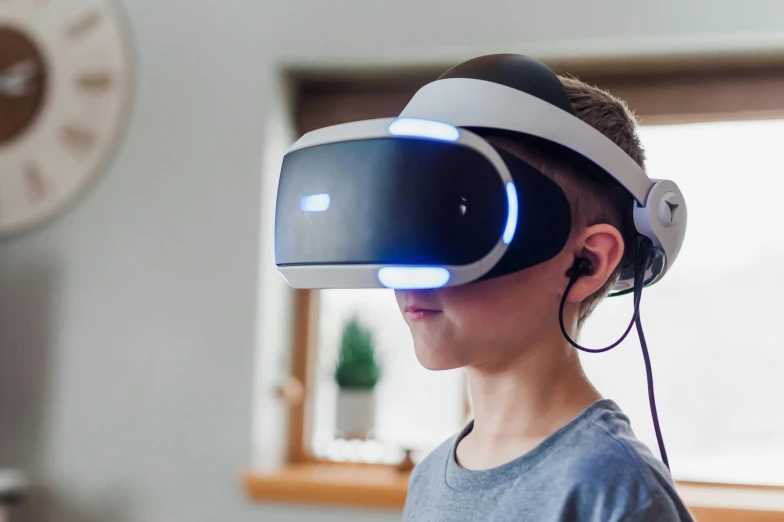 a young boy wearing a virtual reality headset, unsplash, playstation 5, avatar image, full shot photograph, looking partly to the left